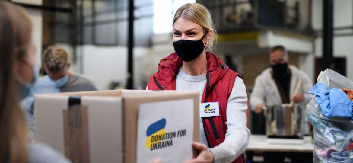 Volunteers collecting donations for the needs of Ukrainian migrants, humanitarian aid concept.