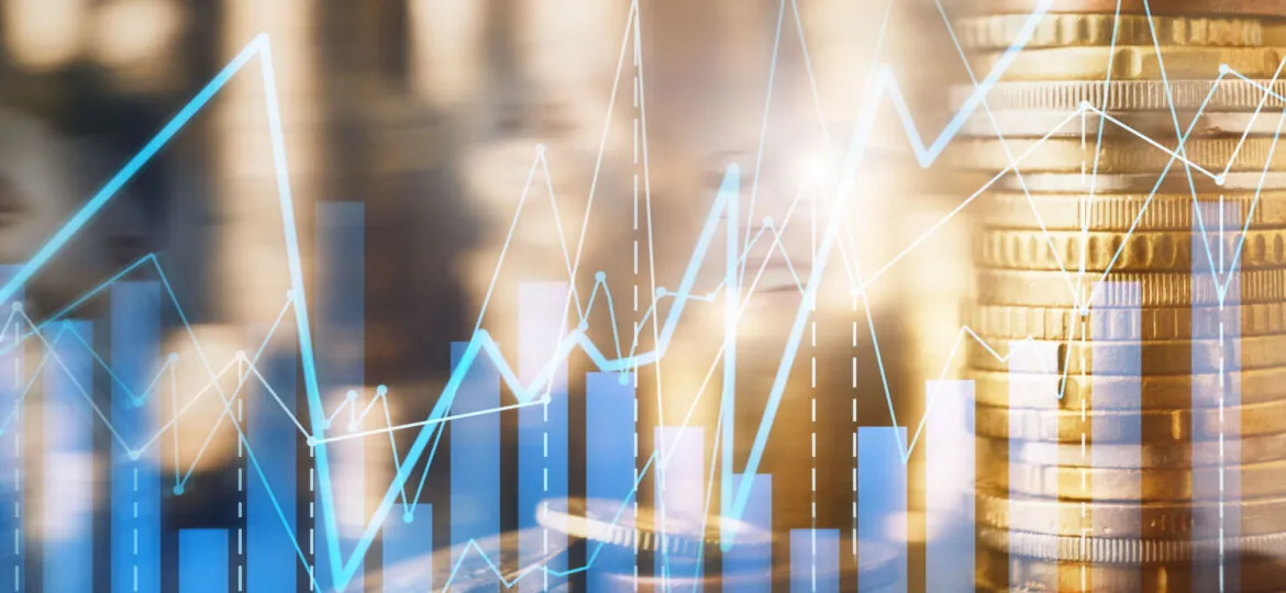 Double exposure of coins stack and financial chart
